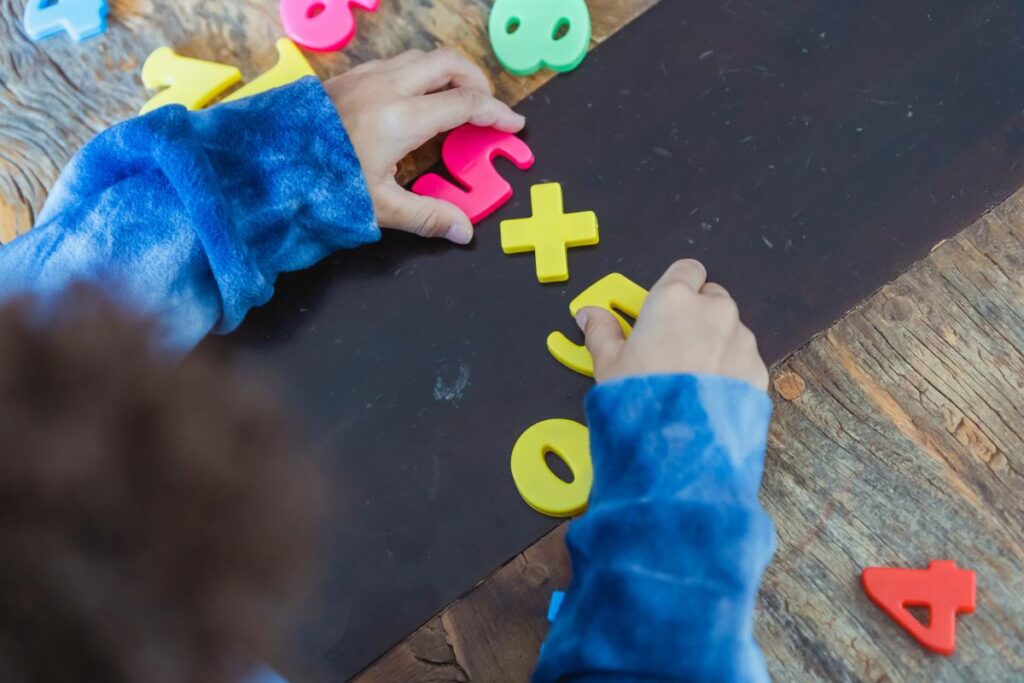 child playing with magnetic letters